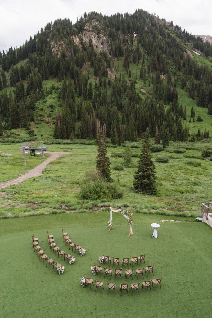 Outdoor wedding ceremony setup surrounded by mountains at Snowpine Lodge in Alta, Utah