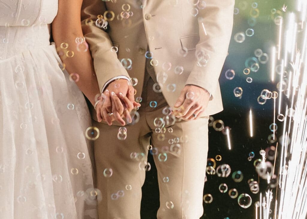 Hailey and Grant holding hands during their bubble wedding send-off at Snowpine Lodge