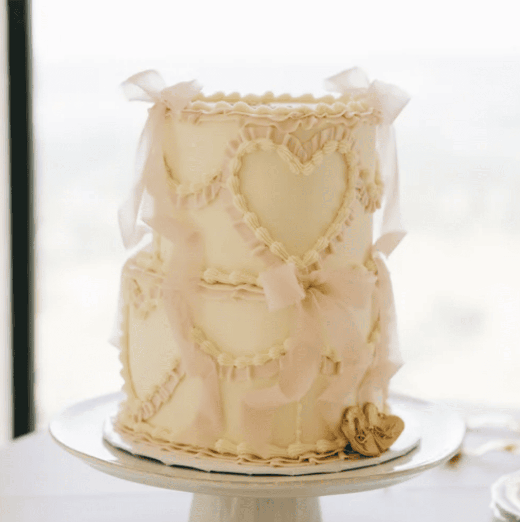 Romantic wedding cake with pink bow details at Ashley and Alex's Siempre reception