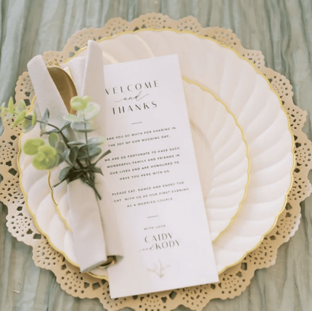 Elegant place setting with welcome card at Caidy and Kody's wedding at Vode